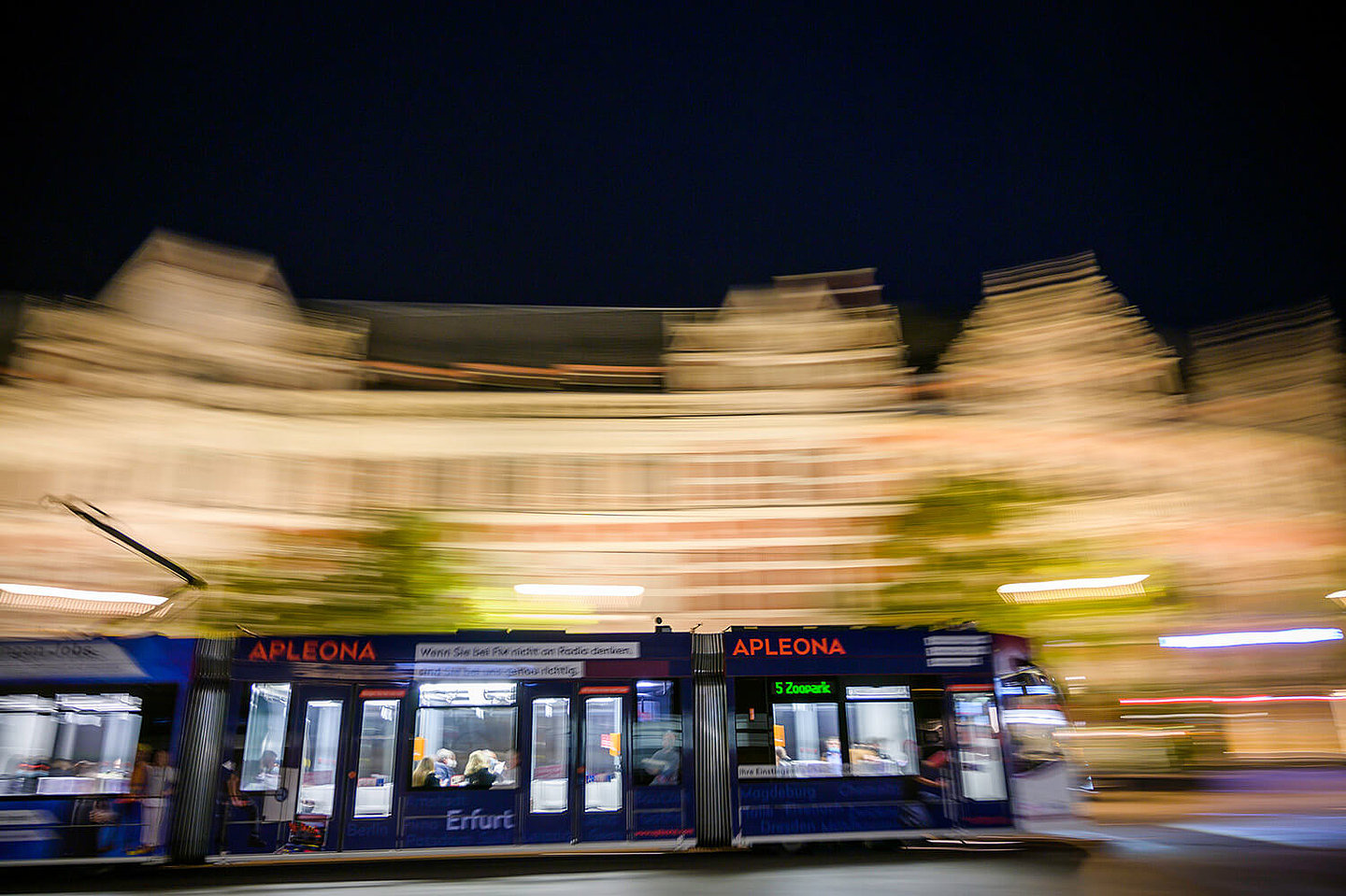 A tram drives through Erfurt's city center at night