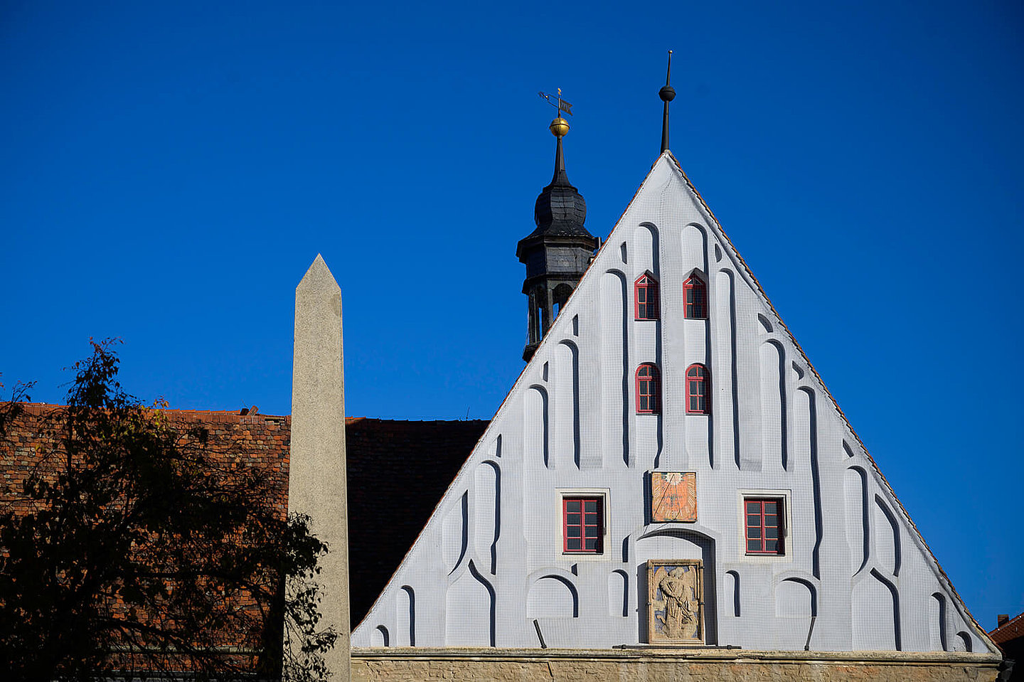Gable wall of the Buttstaedter town hall with a bell tower and an obelisk