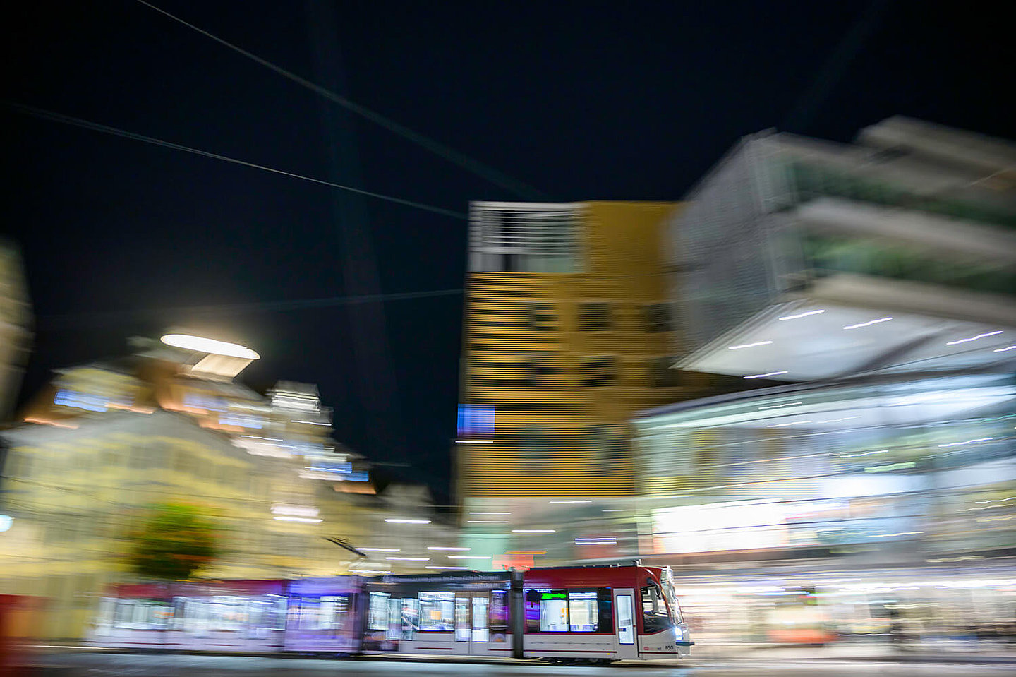A tram drives through Erfurt's city center at night