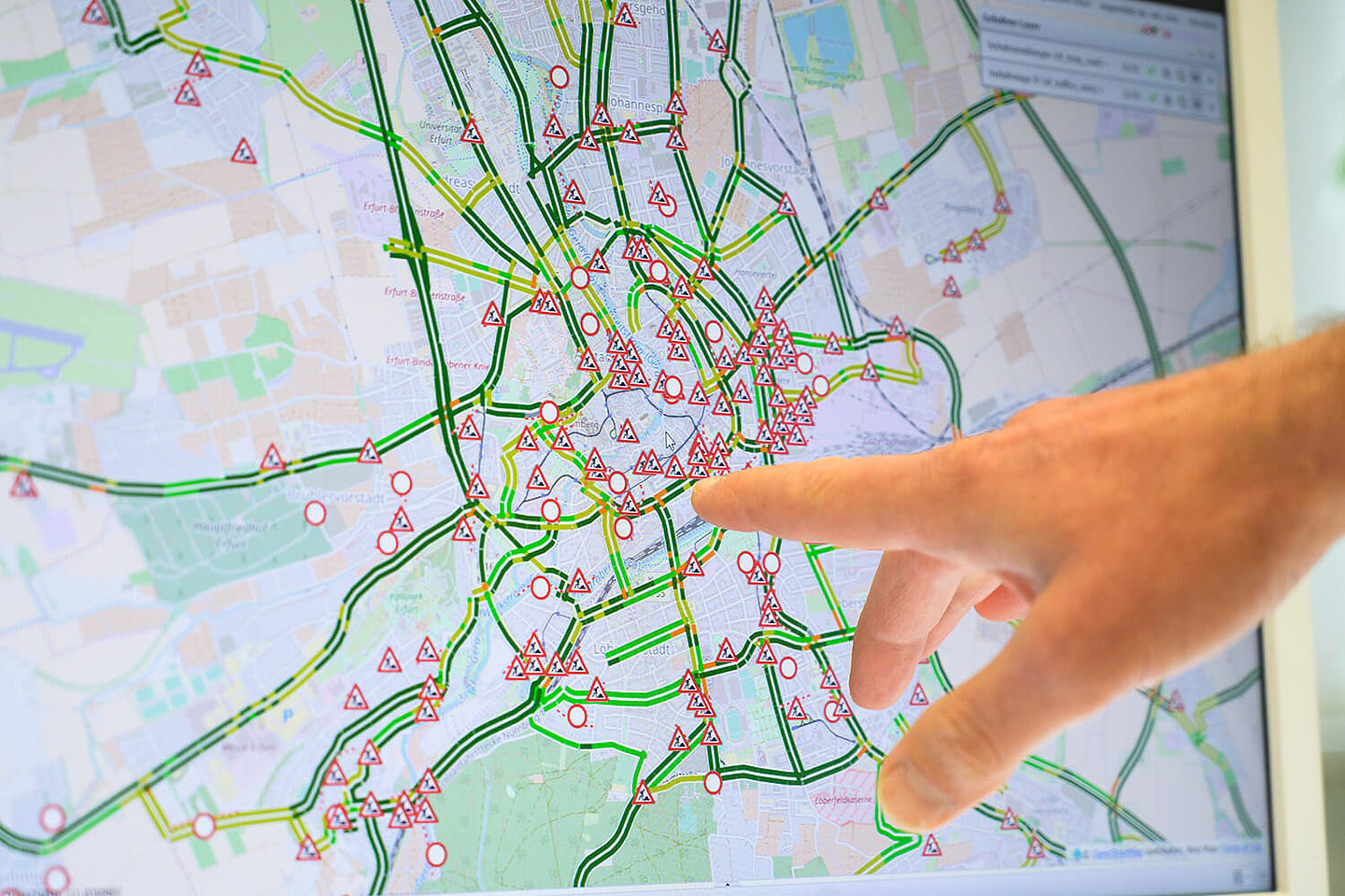 A hand points to a city map showing all construction sites